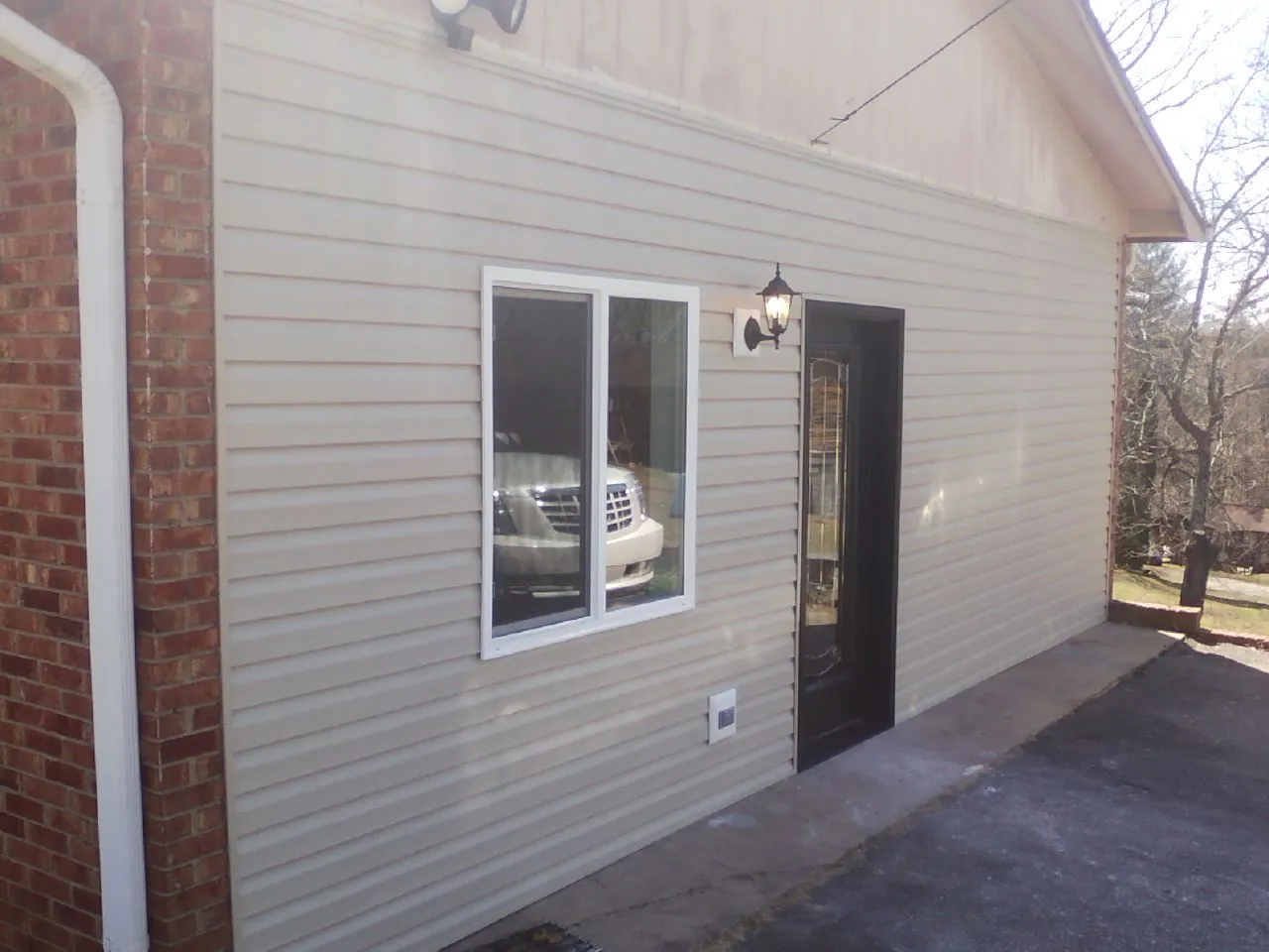 New vinyl siding and entry door on a room addition in Hebron